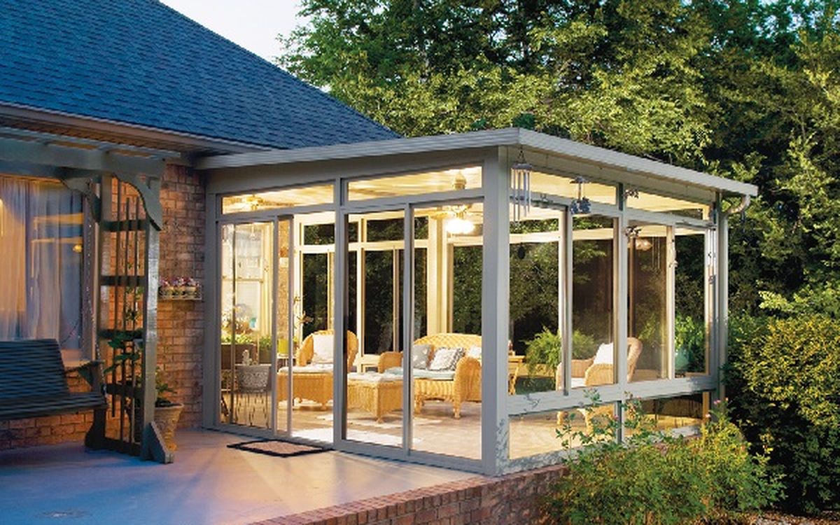 A renovated sunroom extension with glass walls opening to a garden